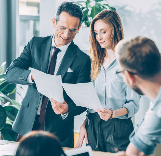 man, woman and onlooker reviewing Home Loan Title in Rogers, AR, Springdale, Bentonville, Bella Vista, AR, Fayetteville, AR and Nearby Cities