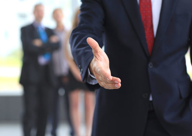 man offering to shake hands for a real-estate title search
